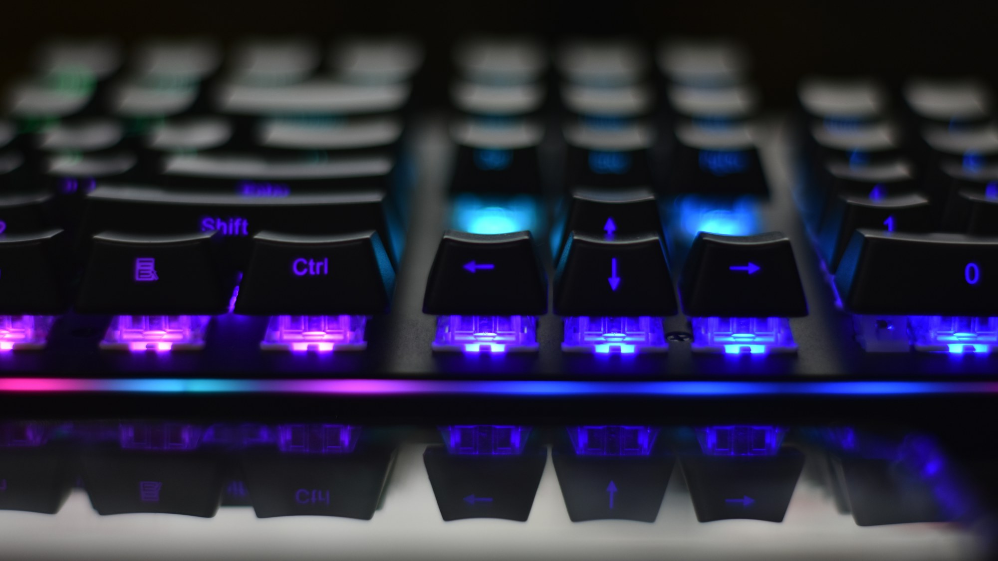 Close-up of an illuminated mechanical gaming keyboard. Photo by John Petalcurin on Unsplash.